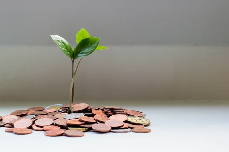 Coins and savings jar representing bank savings and fixed deposits in India