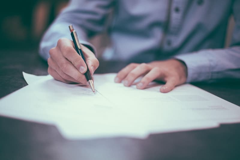 Business professional reviewing a quotation document at desk